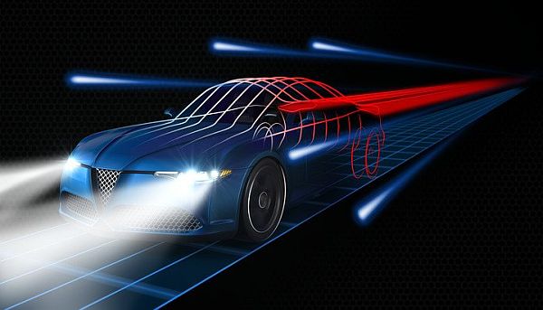 A futuristic car with bright headlights driving on a winding road at night, surrounded by glowing city lights.