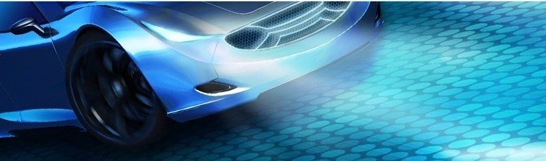 A close-up view of a modern electric vehicle charging station with a glowing LED display and charging cable.